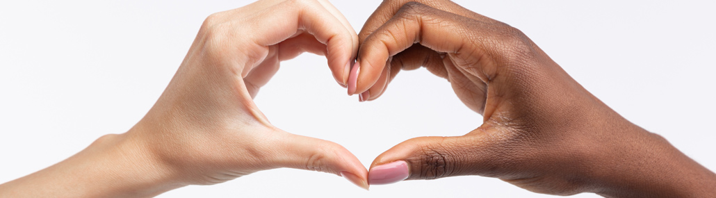 A photograph of hands forming a heart